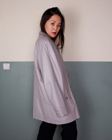 This grey spring coat combines vintage vibes with shoulder pads for a touch of 80s flair.