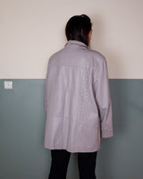 This grey spring coat combines vintage vibes with shoulder pads for a touch of 80s flair.