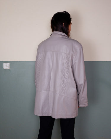 This grey spring coat combines vintage vibes with shoulder pads for a touch of 80s flair.