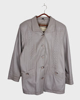 This grey spring coat combines vintage vibes with shoulder pads for a touch of 80s flair.
