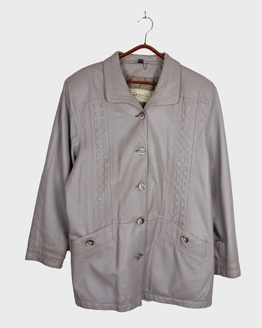 This grey spring coat combines vintage vibes with shoulder pads for a touch of 80s flair.