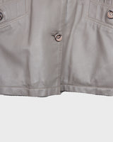This grey spring coat combines vintage vibes with shoulder pads for a touch of 80s flair.