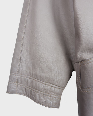 This grey spring coat combines vintage vibes with shoulder pads for a touch of 80s flair.