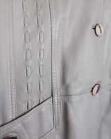 This grey spring coat combines vintage vibes with shoulder pads for a touch of 80s flair.