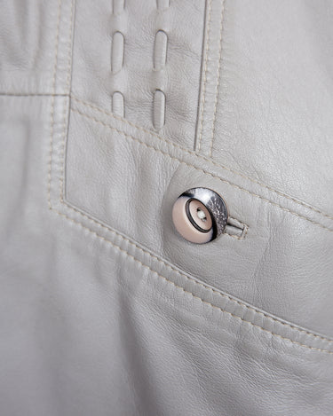 This grey spring coat combines vintage vibes with shoulder pads for a touch of 80s flair.