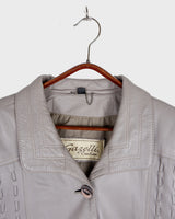 This grey spring coat combines vintage vibes with shoulder pads for a touch of 80s flair.