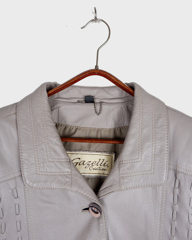 This grey spring coat combines vintage vibes with shoulder pads for a touch of 80s flair.