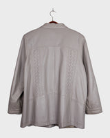 This grey spring coat combines vintage vibes with shoulder pads for a touch of 80s flair.