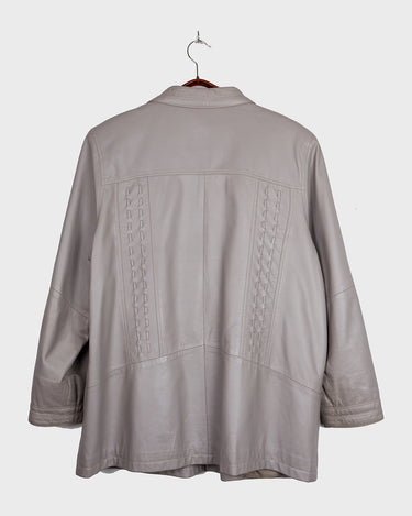 This grey spring coat combines vintage vibes with shoulder pads for a touch of 80s flair.