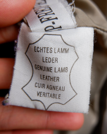 This grey spring coat combines vintage vibes with shoulder pads for a touch of 80s flair.