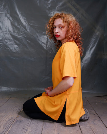 This vintage 90s orange blouse will add a pop of color to your wardrobe. The short sleeves and viscose mix fabric make it lightweight and perfect for any casual occasion!