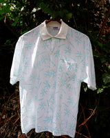 Sun’s out, button up! This Italian vintage white polo shirt brings serious 80s energy with its sharp button-up neckline and eye-catching turquoise pattern. A rare vintage gem that’s equal parts sporty, stylish, and a little cheeky. Wear it loud, wear it proud – this polo’s got main character energy.