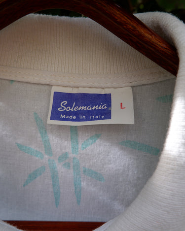 Sun’s out, button up! This Italian vintage white polo shirt brings serious 80s energy with its sharp button-up neckline and eye-catching turquoise pattern. A rare vintage gem that’s equal parts sporty, stylish, and a little cheeky. Wear it loud, wear it proud – this polo’s got main character energy.