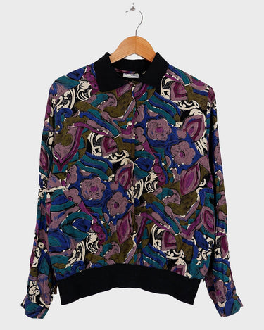 Everyone needs a little 'flare' in their life, and this colorful vintage 80s 90s floral pattern viscose shirt has just that! Perfect for all you flower-power enthusiasts, this shirt features an elastic hem for a snug fit, and adds a vibrant touch to your closet! Go ahead, get groovin'!