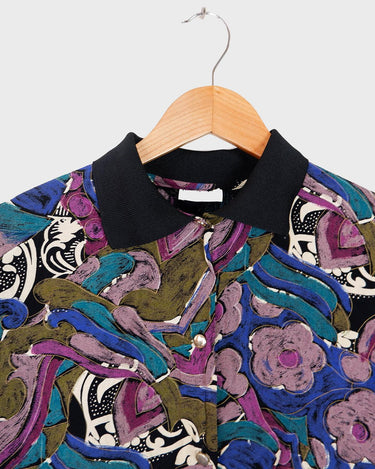 Everyone needs a little 'flare' in their life, and this colorful vintage 80s 90s floral pattern viscose shirt has just that! Perfect for all you flower-power enthusiasts, this shirt features an elastic hem for a snug fit, and adds a vibrant touch to your closet! Go ahead, get groovin'!