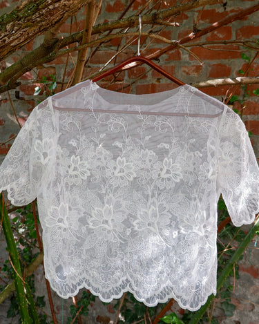 Ditch the boring basics—this handmade lace top is crafted from upcycled curtains. With its romantic vibes, sheer elegance, and intricate embroidery, it’s perfect for layering and embracing your boho side. This one-of-a-kind piece is sustainably made and packed with attitude. Who knew curtains could slay this hard?