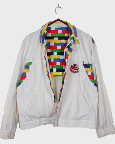 This vintage Missoni Sport windbreaker from the 90s is a standout piece with its bold striped accents and iconic globe logo embroidery. Made in Italy and cut in a comfortable size L, it offers a relaxed fit and lightweight feel – ideal for everyday wear. A rare example of Missoni’s sporty aesthetic, combining timeless design with a splash of color. Effortlessly cool and easy to style.