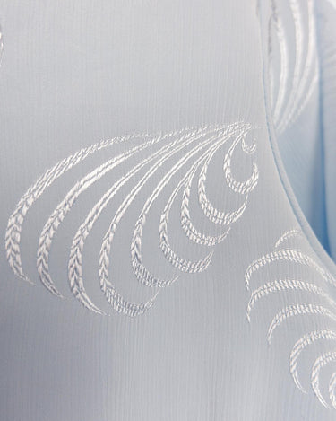 Introduce some sparkle to your style with this vintage 80s light blue blouse. The flattering fit, courtesy of the short sleeves and shoulder pads, meets a playful touch of shimmering pattern. Sparkle on!