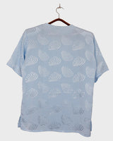 Introduce some sparkle to your style with this vintage 80s light blue blouse. The flattering fit, courtesy of the short sleeves and shoulder pads, meets a playful touch of shimmering pattern. Sparkle on!