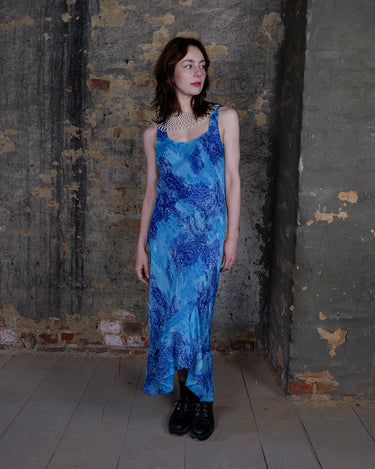 Soft shades of blue and a flowing cut give this 90s maxi dress an easy, fairy-like feel. The asymmetrical hem adds just enough edge to keep it from being too sweet.