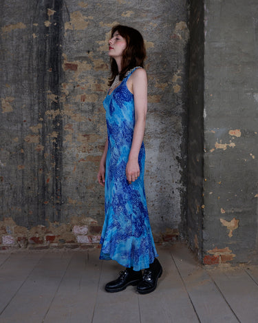 Soft shades of blue and a flowing cut give this 90s maxi dress an easy, fairy-like feel. The asymmetrical hem adds just enough edge to keep it from being too sweet.