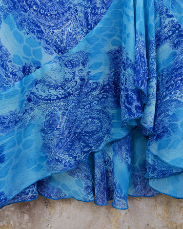 Soft shades of blue and a flowing cut give this 90s maxi dress an easy, fairy-like feel. The asymmetrical hem adds just enough edge to keep it from being too sweet.
