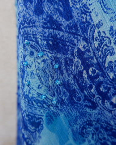 Soft shades of blue and a flowing cut give this 90s maxi dress an easy, fairy-like feel. The asymmetrical hem adds just enough edge to keep it from being too sweet.