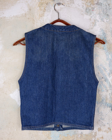 This vintage denim vest is tough, timeless, and ready to layer. It features classic brass snap buttons and four front pockets for that old-school workwear vibe.