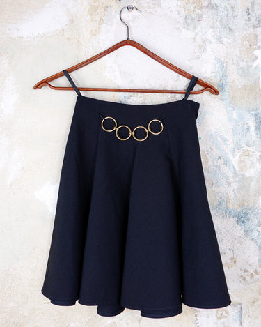 This vintage 90s mini skirt with bold gold ring details is a true statement piece with attitude. Vintage, but made for now.
