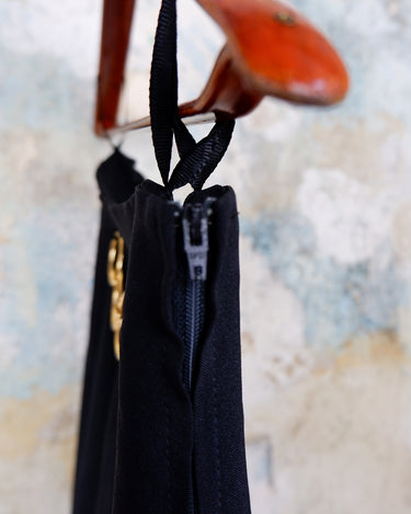 This vintage 90s mini skirt with bold gold ring details is a true statement piece with attitude. Vintage, but made for now.