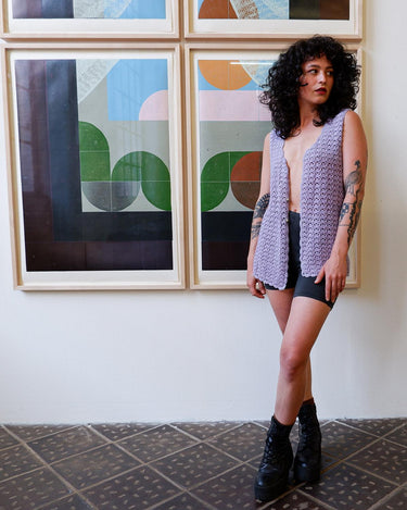 Add a pop of color to your wardrobe with this hand-crocheted purple vest. Made with love and perfect for layering, its long fit will give you an effortlessly look.
