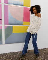 Say goodbye to basic sweaters! This handmade white sweater with dramatic flared sleeves is sure to make a statement. Who needs plain when you've got flair?!