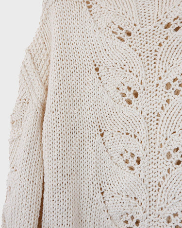 Say goodbye to basic sweaters! This handmade white sweater with dramatic flared sleeves is sure to make a statement. Who needs plain when you've got flair?!