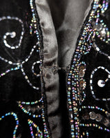 This vintage vest packs the perfect punch of 80s style! With its black velvet material and subtle shimmer of embroidered pailettes, you'll ready to sparkle.