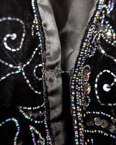This vintage vest packs the perfect punch of 80s style! With its black velvet material and subtle shimmer of embroidered pailettes, you'll ready to sparkle.