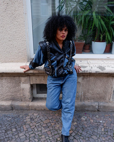 This vintage 80s masterpiece is a patch-perfect combination of denim and leather! Made with premium materials to give your look a unique edge. Adjustable sleeves with a zipper can easily transform it into a vest. Go ahead, have fun with your style!