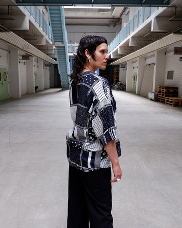 90s minimalism, but make it wild. This black and white vintage shirt throws dots, stripes, and checks into a bold mashup that just works. Soft viscose-cotton blend, boxy fit, serious graphic energy. Monochrome, but far from boring.