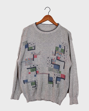 Snatch up this vintage 80s gem! Our grey sweater features a distinctly retro design, with an eye-catching, geometric pattern in a rainbow of colors