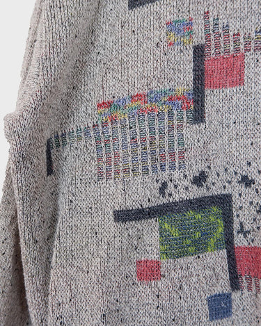 Snatch up this vintage 80s gem! Our grey sweater features a distinctly retro design, with an eye-catching, geometric pattern in a rainbow of colors