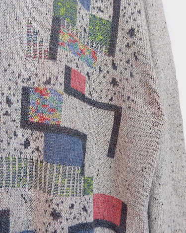 Snatch up this vintage 80s gem! Our grey sweater features a distinctly retro design, with an eye-catching, geometric pattern in a rainbow of colors.