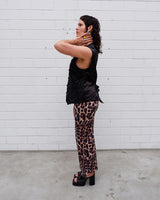 This Y2k black vest blends classic baroque style with a subtle gothic edge. The textured floral pattern and fleur-de-lis buttons give it a refined yet bold character. Cool, confident and a little unexpected – a standout piece without shouting.