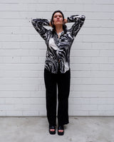 This black and white shirt doesn’t ask for attention — it just gets it. The abstract swirl pattern gives effortless chaos in the best way possible. Throw it on and let the print do the talking!