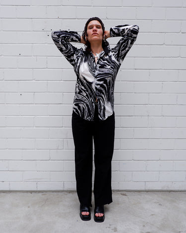 This black and white shirt doesn’t ask for attention — it just gets it. The abstract swirl pattern gives effortless chaos in the best way possible. Throw it on and let the print do the talking!