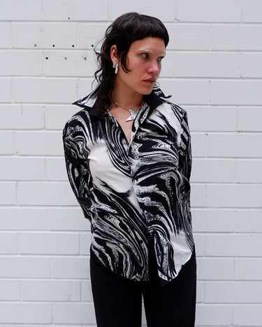 This black and white shirt doesn’t ask for attention — it just gets it. The abstract swirl pattern gives effortless chaos in the best way possible. Throw it on and let the print do the talking!