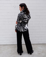 This black and white shirt doesn’t ask for attention — it just gets it. The abstract swirl pattern gives effortless chaos in the best way possible. Throw it on and let the print do the talking!