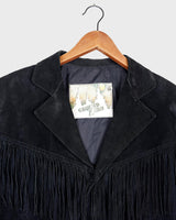Classy with a hint of wild! This vintage 80s black fringe leather jacket features edgy shoulder pads and flowing fringes. Make a style statement fit for any sassy bohemian lover! 