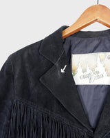Classy with a hint of wild! This vintage 80s black fringe leather jacket features edgy shoulder pads and flowing fringes. Make a style statement fit for any sassy bohemian lover! 