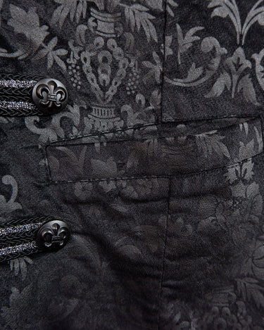 This Y2k black vest blends classic baroque style with a subtle gothic edge. The textured floral pattern and fleur-de-lis buttons give it a refined yet bold character. Cool, confident and a little unexpected – a standout piece without shouting.