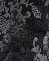 This Y2k black vest blends classic baroque style with a subtle gothic edge. The textured floral pattern and fleur-de-lis buttons give it a refined yet bold character. Cool, confident and a little unexpected – a standout piece without shouting.