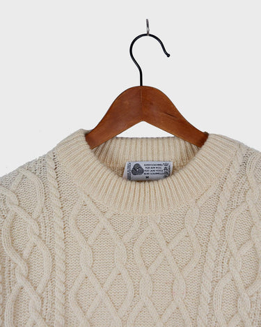 This vintage 90s white wool cable knit sweater is sure to become your comfy go-to! Throw it on and you'll instantly feel warm and cozy - this sweater's guaranteed to be your 'wear me anywhere' sidekick!